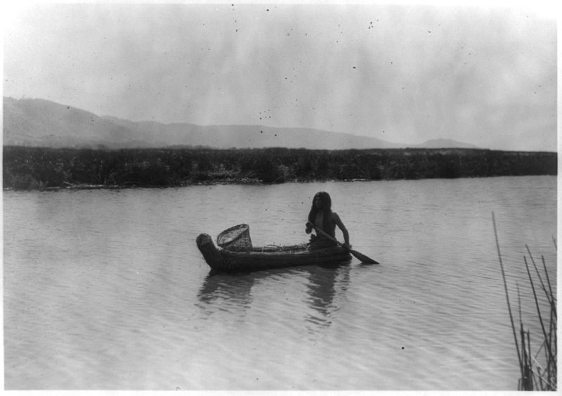 Polo man in tule boat with tule basket (photo credit: Edward S. Curtis)